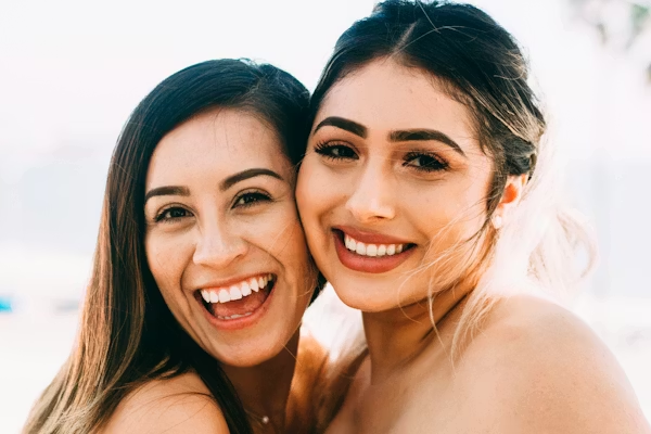 two beautiful women with perfect smiles