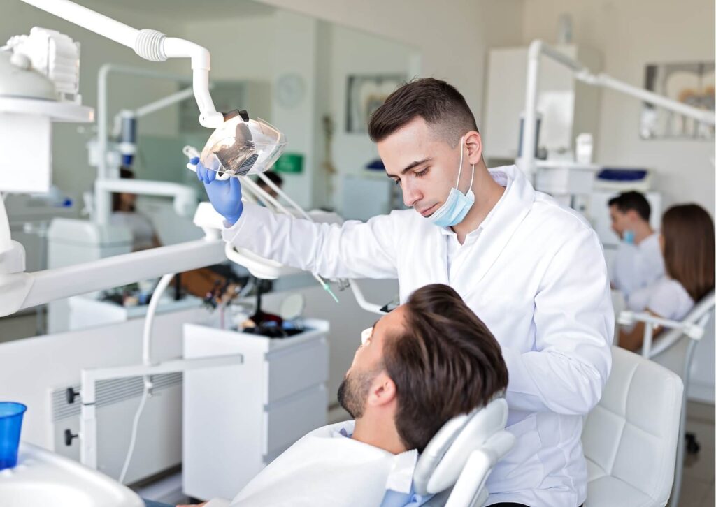 Dentist performing a root canal treatment on a patient before discussing post-procedure recovery and driving recommendations.